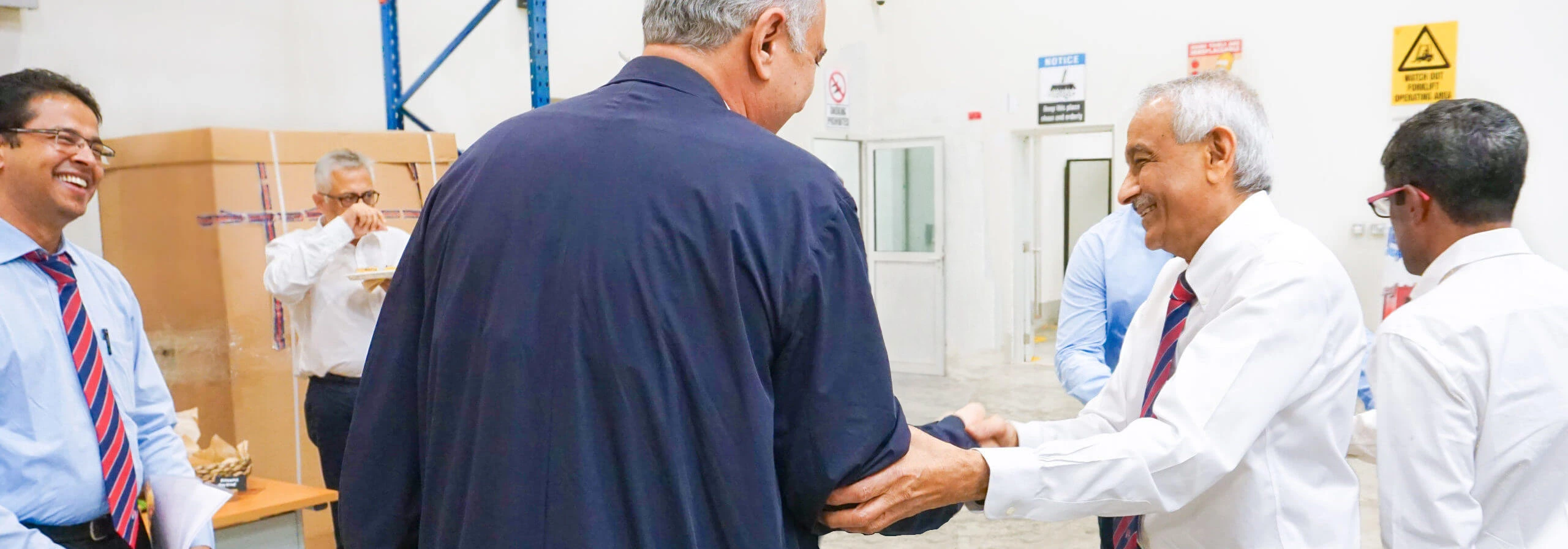 CEO With Costumer Dahbashi CEO shaking hands with costumer around with dahbashi employees